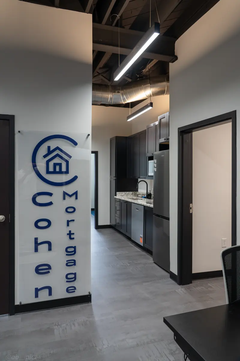 Cohen Mortgage logo wall in the office hallway